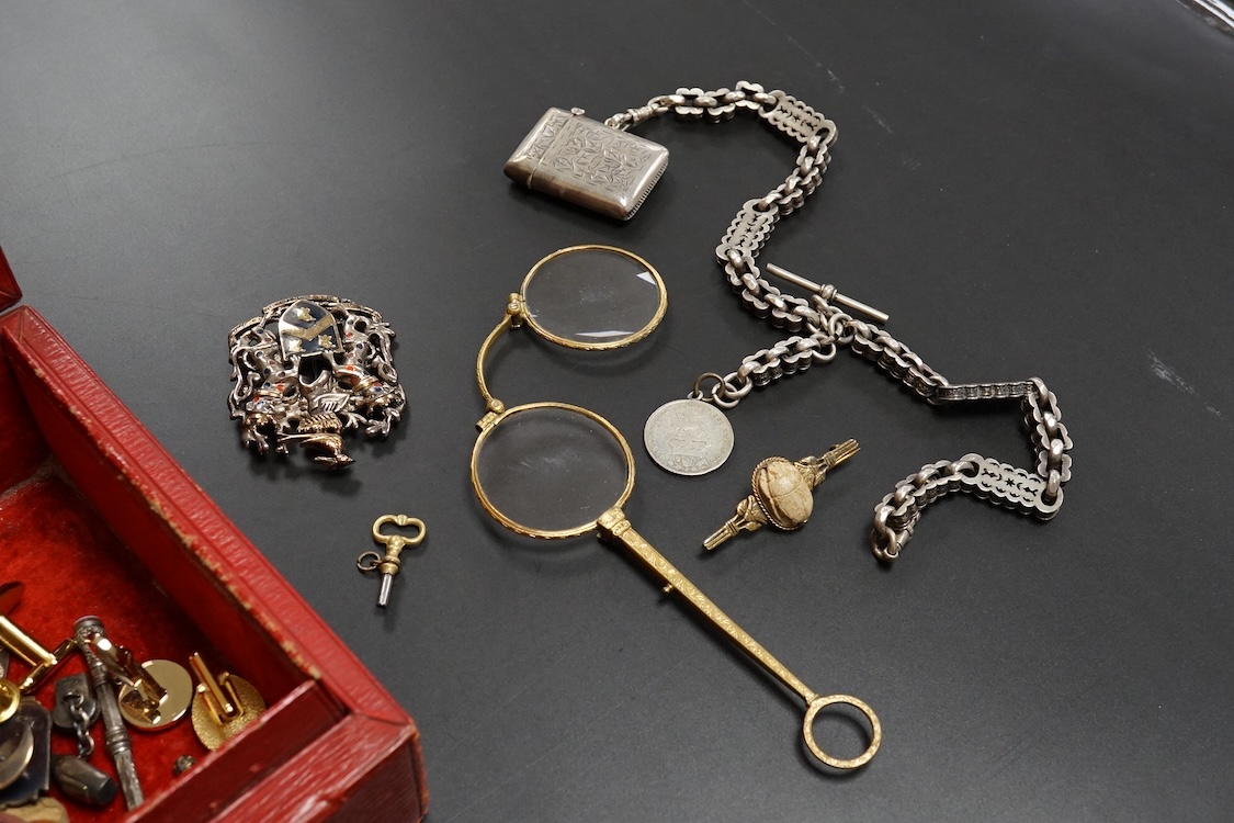 A small group of assorted jewellery and other items including a Victorian white metal albert, hung with a silver vesta case, a pair of gilt metal lorgnettes, cufflinks, scarab brooch and a white metal propelling pencil,